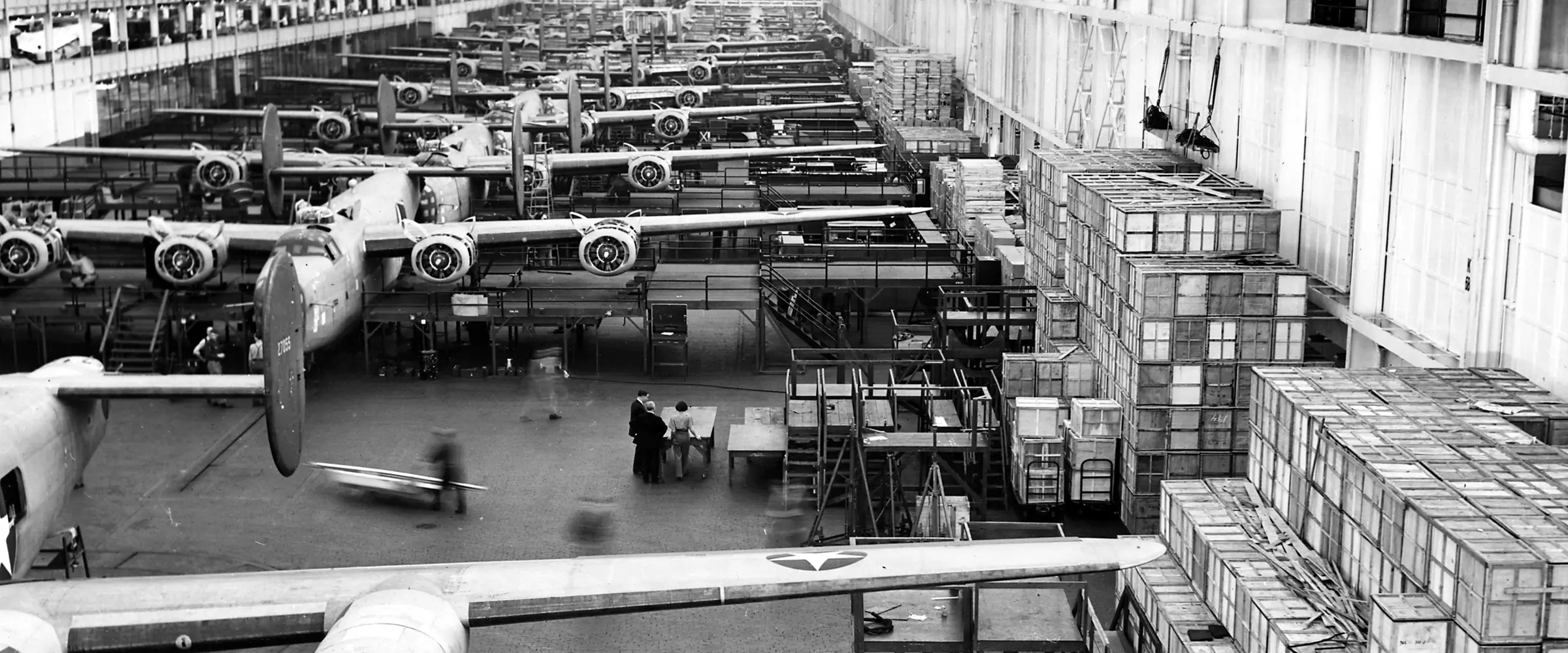 B-24 Liberator bombers nose to tail down an assembly line at Ford's Willow Run plant in 1943