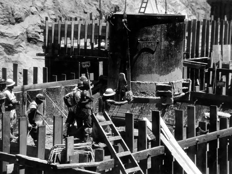 Workers place concrete in the foundation forms of Boulder Dam in 1933
